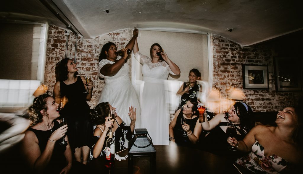 Two brides drinking on a table at West Mill Derby