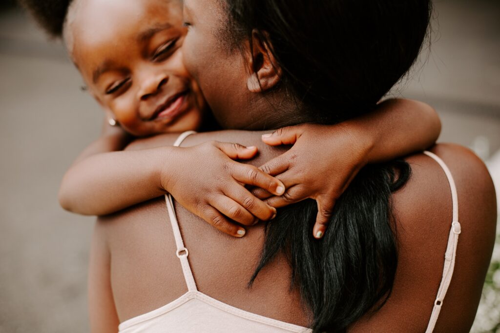 little girl gives her mum massive hug, family portraits